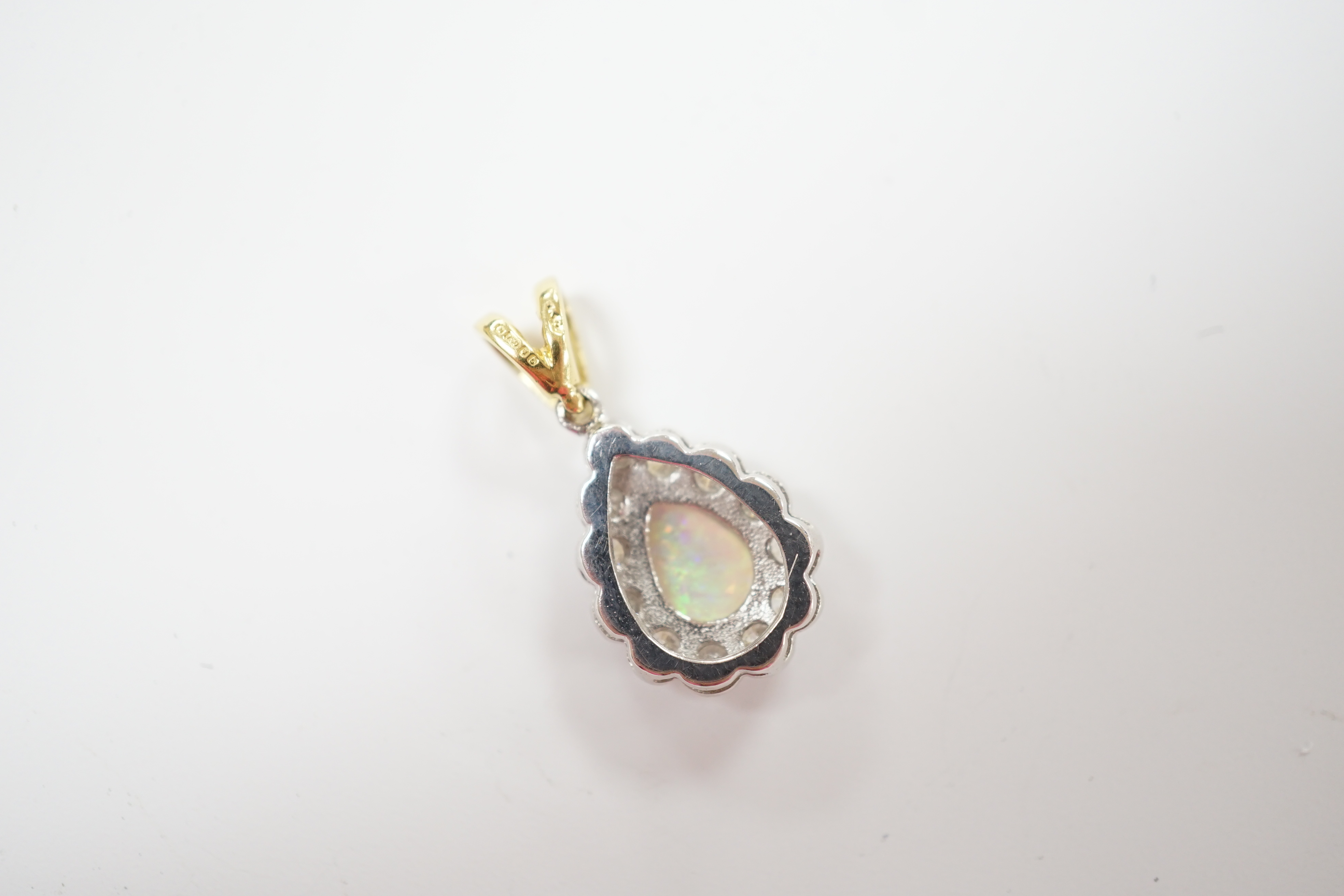 A modern 18ct gold, white opal and diamond set pear shaped cluster pendant, overall 23mm, gross weight 2.6 grams.